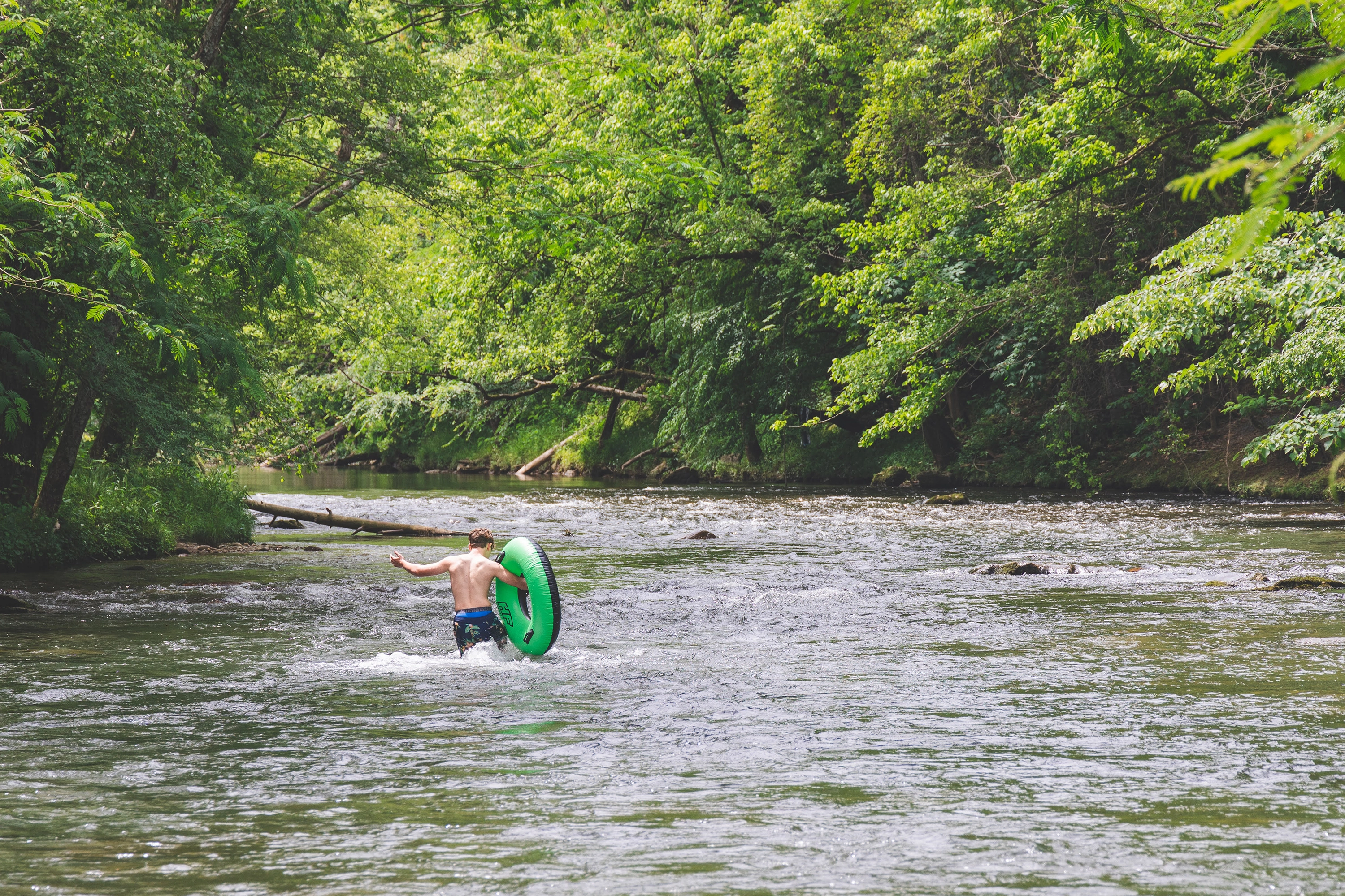 Person tubing on lake