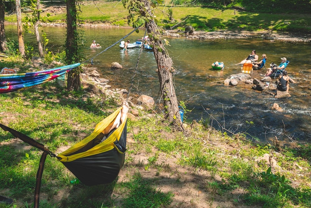people by river at campground